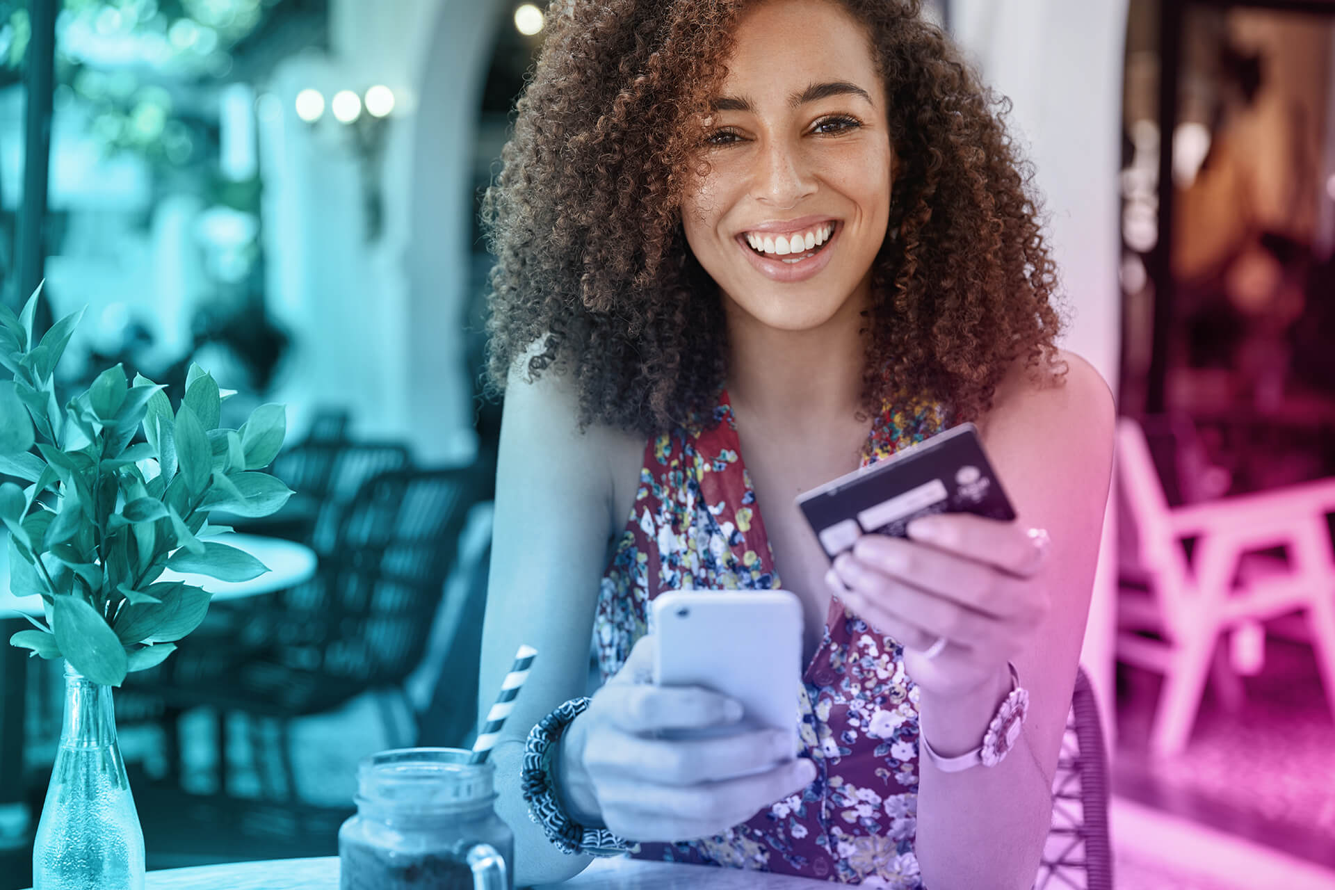 internet-banking-ecommerce-concept-happy-young-smiling-female-with-afro-hairstyle-uses-modern-cell-phone-credit-card-online-shopping (1)-1
