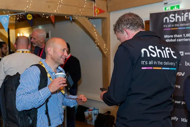 Attendees networking at the nShift stand