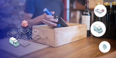 Man holding bottle of wine in wooden box on counter