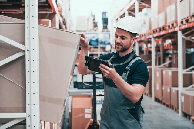 small-SINGLE-IMAGE_young-white-male-warehouse-worker-retrieving-package-from-self-rack-full-colour_july25